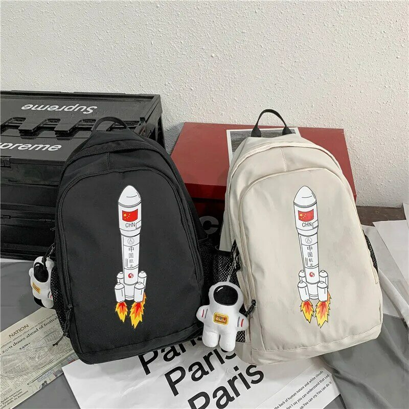 Mochila Kawaii con patrón de cohete de dibujos animados Unisex y gran capacidad mochila escolar para pareja de estudiantes para enviar colgante de muñeca