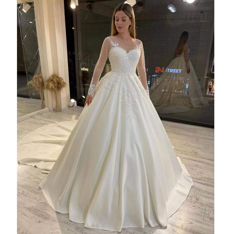 Elegancka luksusowa suknia ślubna Satin frezowanie cekinami aplikacje z długim rękawem O-Neck Sweep pociąg suknie ślubne Robe De Mariée