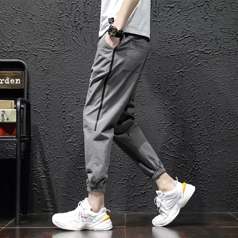 Celana panjang pria, celana panjang lelaki tambal sulam warna polos dasar kancing elastis tali serut gaya Korea kasual Linen untuk lelaki