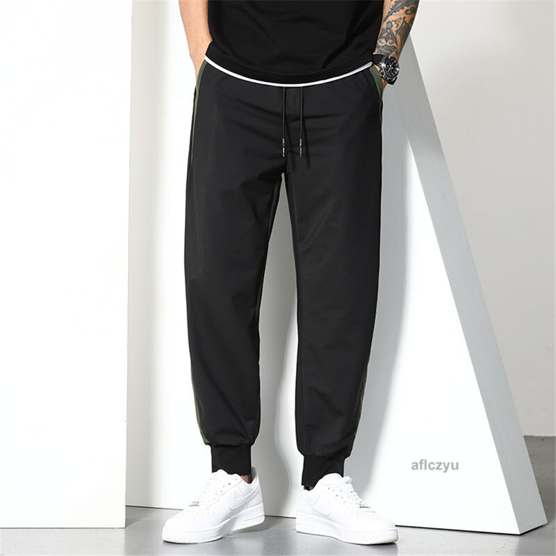 Czarne spodnie do biegania męskie letnie workowate spodnie Plus rozmiar 6XL modne patchworkowy w stylu Casual spodnie męskie duży rozmiar 6XL