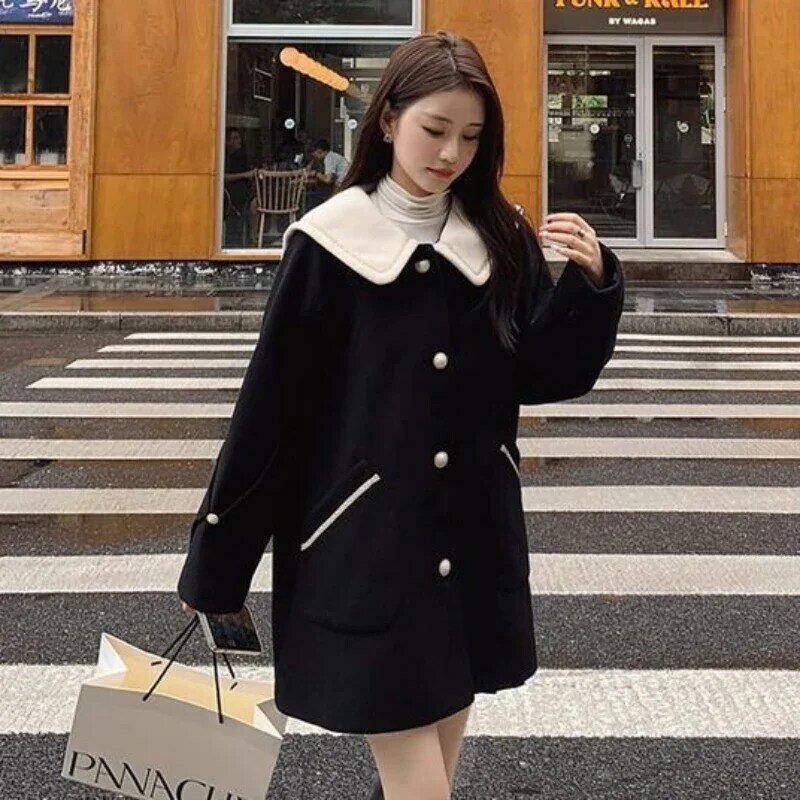 Zimowy nowy damski wysokiej jakości czarny wełniany płaszcz damski niszowy Temperament luźna odzież średniej długości swobodny płaszcz