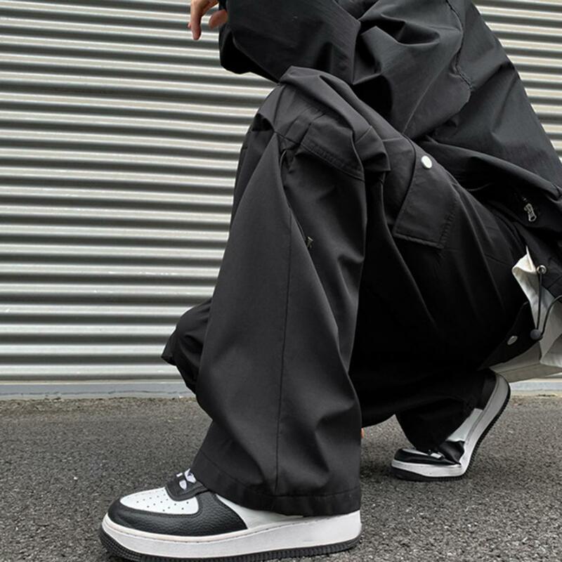 Męskie spodnie ściągany sznurkiem w pasie w stylu ulicznym męskie spodnie Cargo z szeroką nogawką wiele kieszeni elastyczną talią jednolity kolor do noszenia