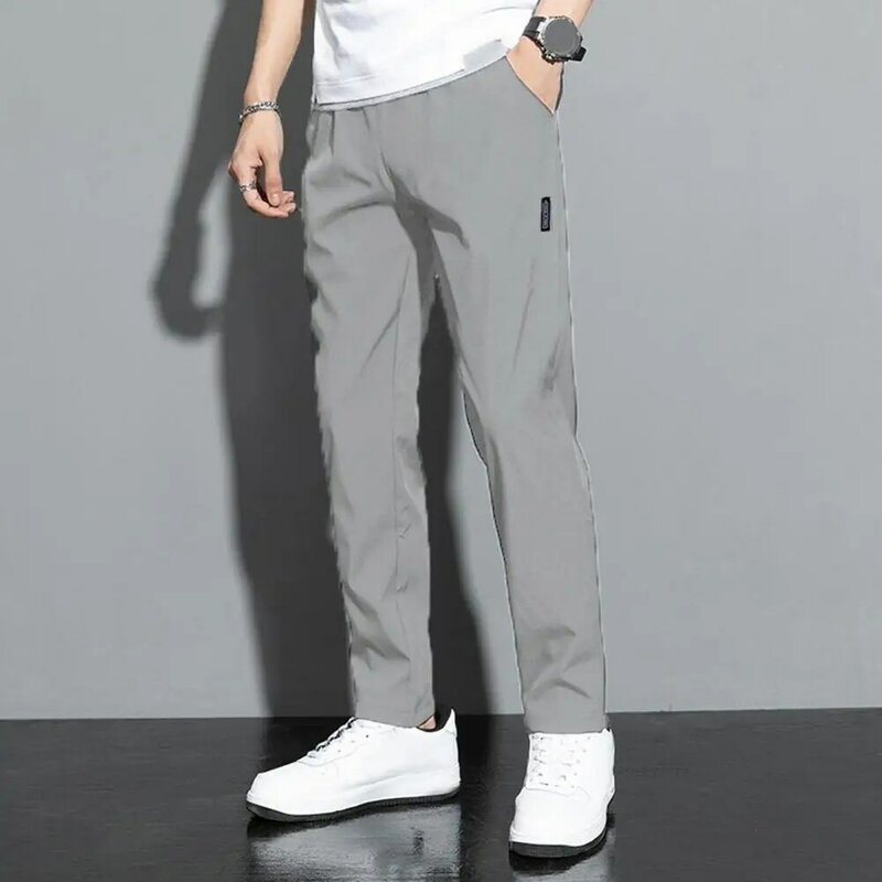 Calça reta suave e respirável masculina, calça casual de cintura média, rápida secagem, bolsos soltos, cor sólida, longa