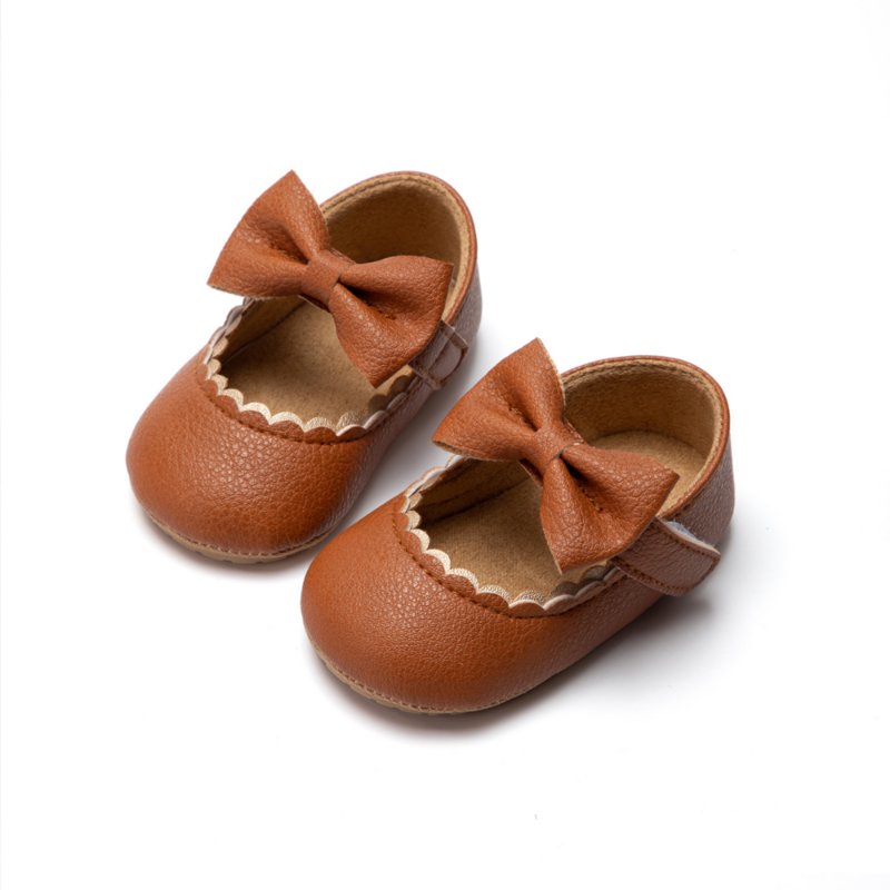 أحذية للأطفال حديثي الولادة من جلد البولي يوريثان أحذية مصنوعة من الجلد مع نعل سفلي من المطاط أحذية مزودة بعقدة فراشات غير قابلة للانزلاق أحذية للأطفال لمشوا الأولى أحذية للأطفال في سن الحبو