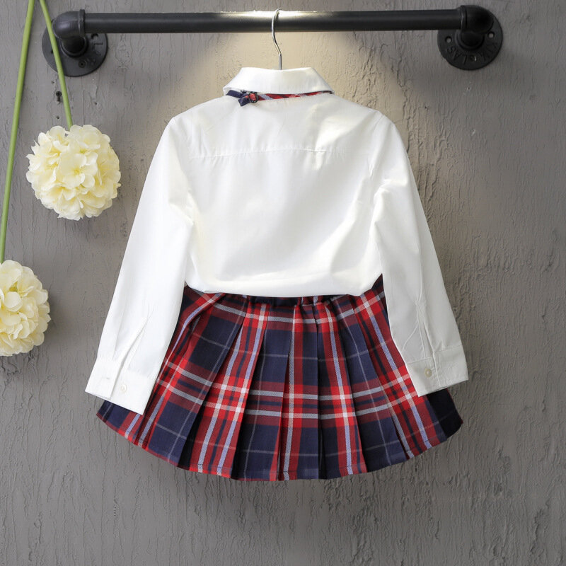 Camisa branca pura estilo britânico, saia xadrez e arco, uniforme escolar infantil, terno de menina, roupa casual, primavera, verão, outono, 2023