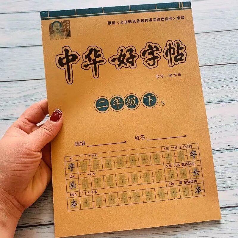 Siswa sekolah dasar praktek kaligrafi dengan disinkronkan karakter Tiongkok 300 kata untuk karakter baru anak-anak
