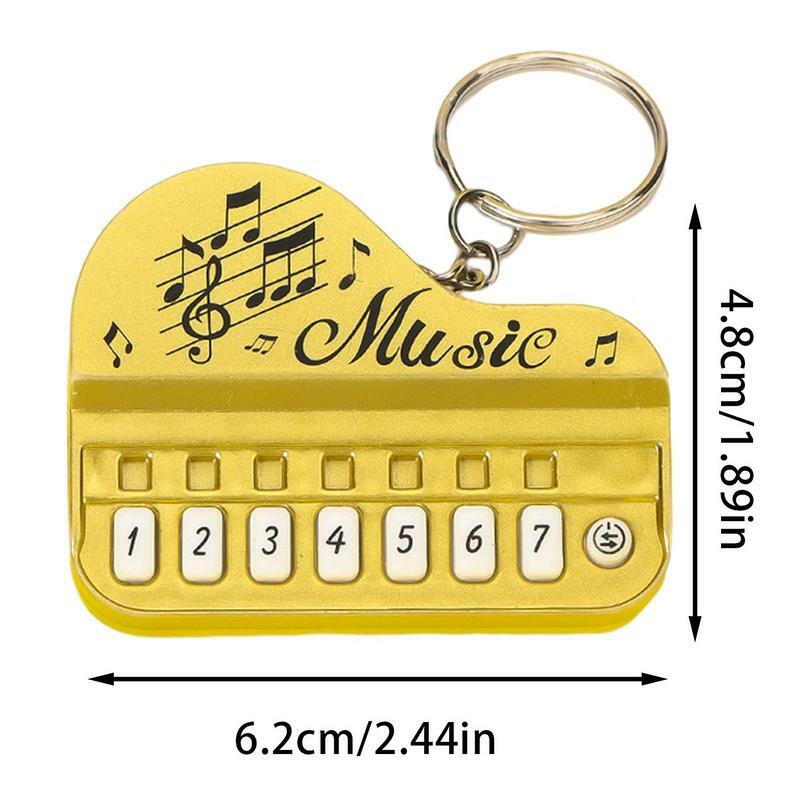 พวงกุญแจเปียโนนิ้วเล่นได้พวงกุญแจขนาดเล็กใช้งานได้จริงพร้อมไฟอุปกรณ์เครื่องดนตรีพวงกุญแจจี้ของขวัญ