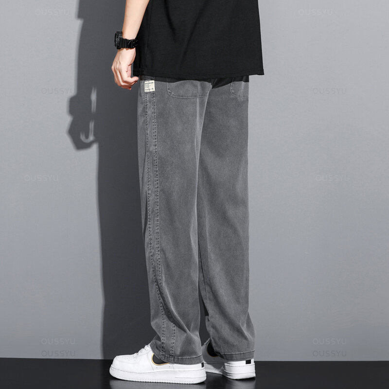 Letnia miękka tkanina z lyocellu męskie dżinsy cienkie luźne proste spodnie ze sznurkiem elastyczna talia koreańska spodnie typu Casual Plus Size M-5XL