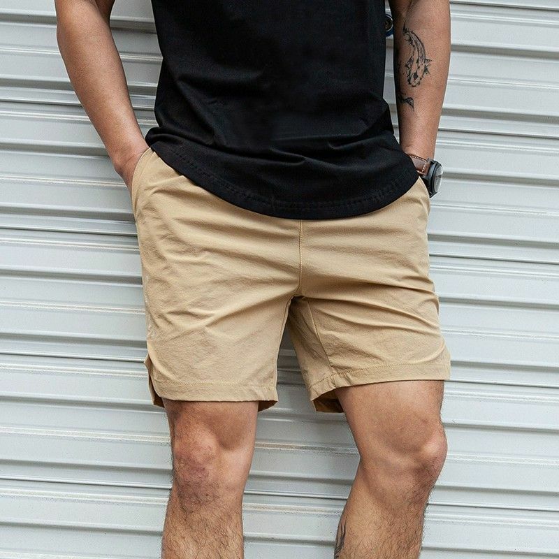 Celana pendek kasual berenda elastis untuk pria, celana pendek warna polos longgar netral dengan saku bercetak huruf Musim Panas 2024