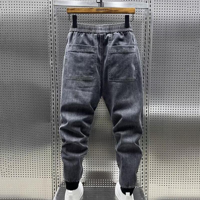 Celana panjang Jeans elastis pria, celana panjang pinggang tali serut desain kantung warna Solid kasual Harem