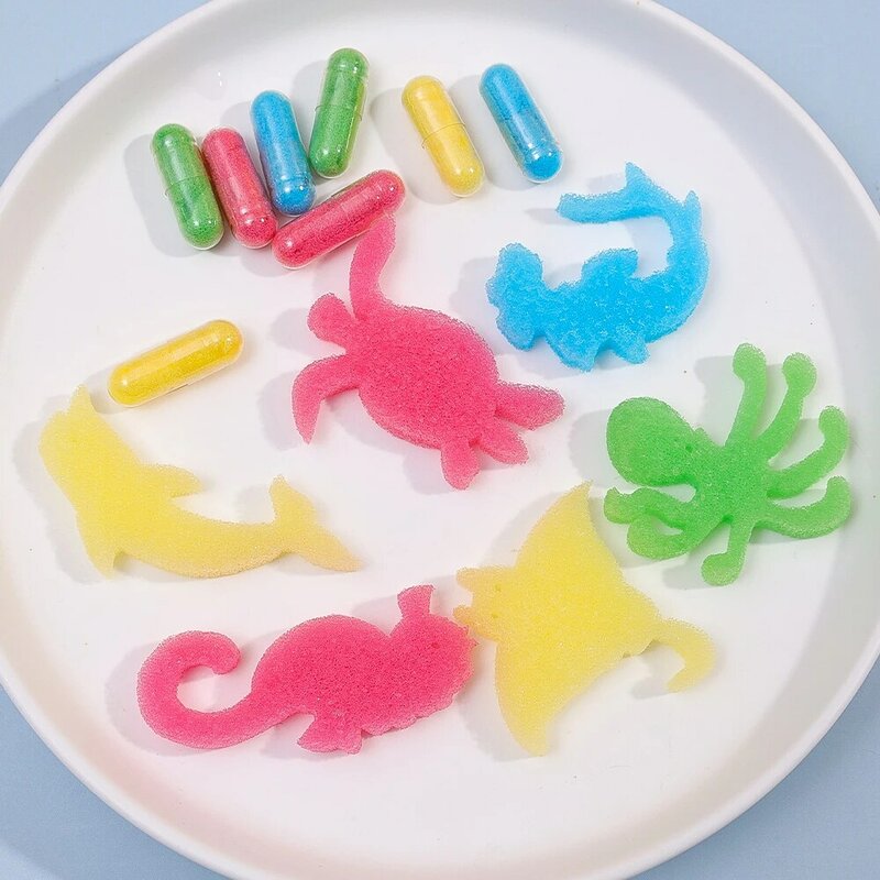 Juego creativo de agua de remojo para niños, juguetes de cápsula de esponja grande, forma de Animal marino de dinosaurio, rompecabezas de natación de baño, 12 piezas