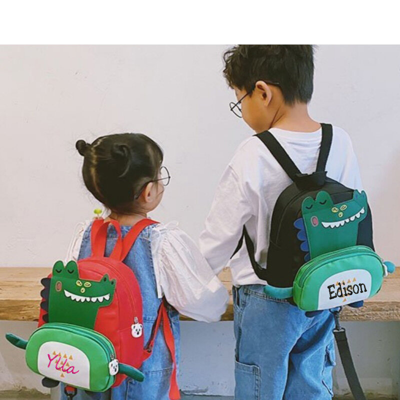 กระเป๋าเด็กลายไดโนเสาร์ tas ransel anak Laki Laki การ์ตูนน่ารักป้องกันการสูญหายของเด็กกระเป๋าเป้สะพายหลังโรงเรียนอนุบาลแบบส่วนบุคคล