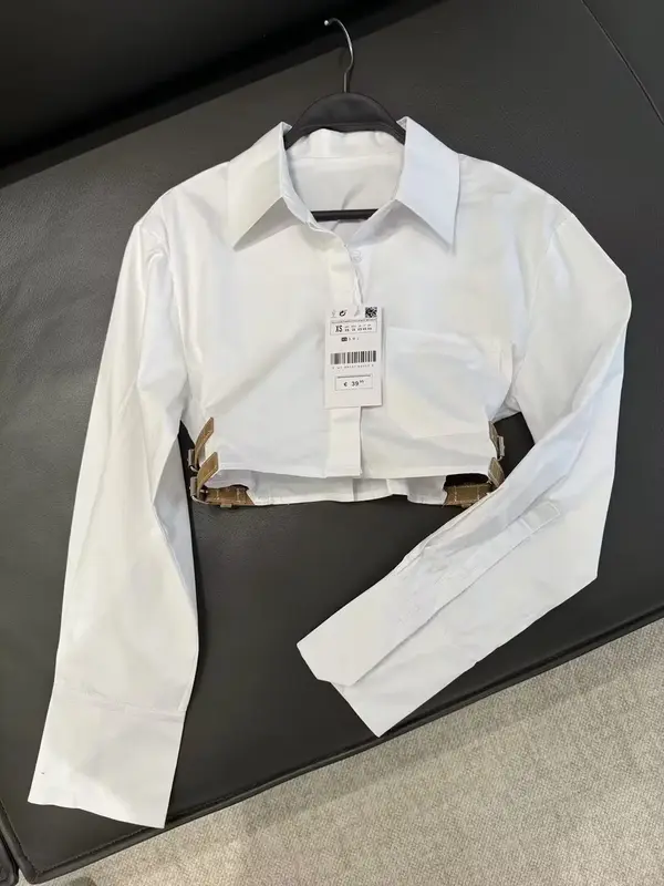 Camisa de solapa de tela cortavientos corta con decoración de cinturón para mujer, camisa retro de manga larga con botones, top elegante, nueva moda