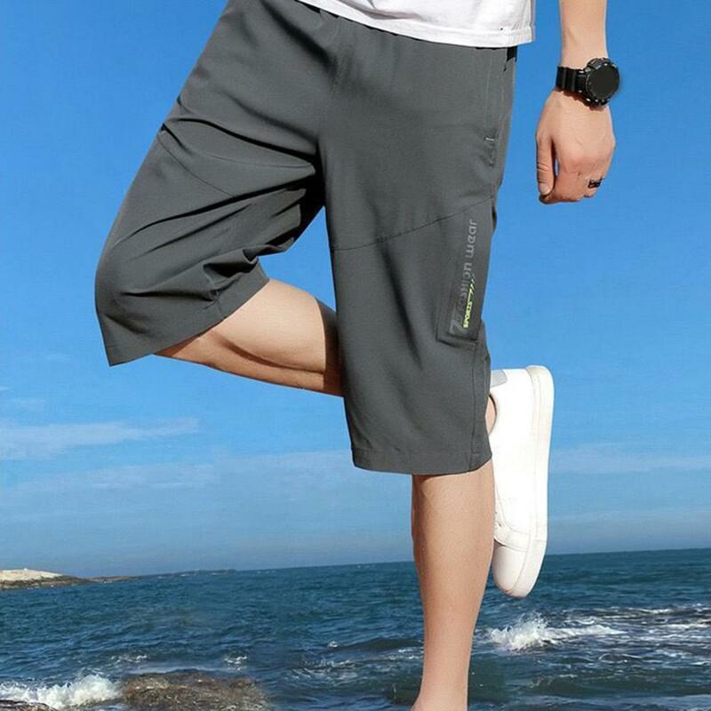 Celana crop warna Solid pria, bawahan pinggang elastis dengan saku ritsleting, bernafas setengah betis nyaman