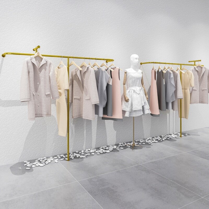 Estante de exhibición de oro personalizado de alta gama, estante de ropa montado en la pared para tienda minorista