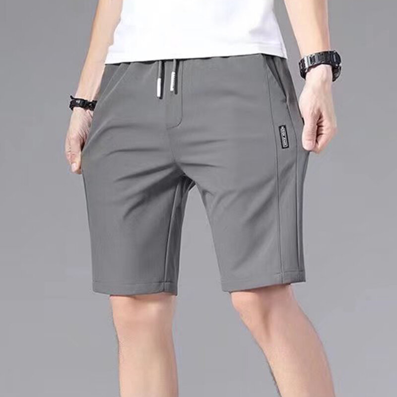 Celana pendek olahraga pria, celana pendek Jogging kasual tali pinggang elastis longgar pola lurus warna polos musim panas untuk lelaki