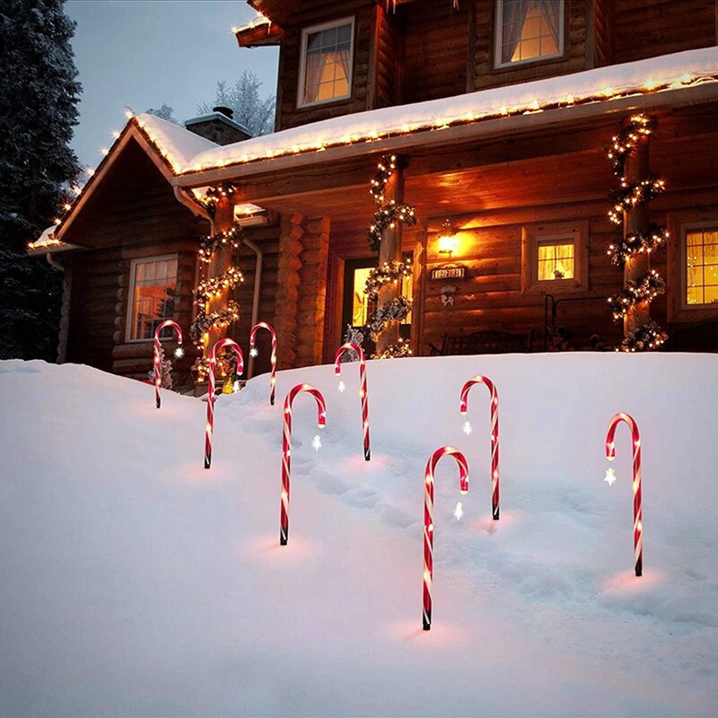 As luzes da cana dos doces do Natal, o caminho vermelho e branco que faz luzes, jardim exterior iluminam a paisagem, 15"