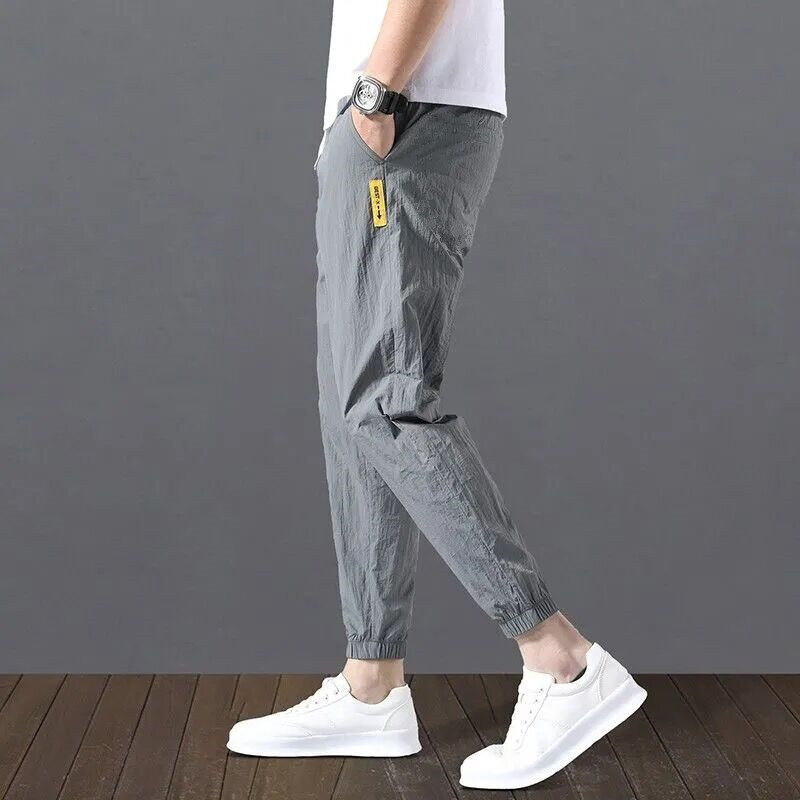 Ice Silk Celana Fashion Korea Musim Panas Pria Celana Sembilan Titik Longgar Celana Panjang Klasik Serut Pinggang Elastis Jogging
