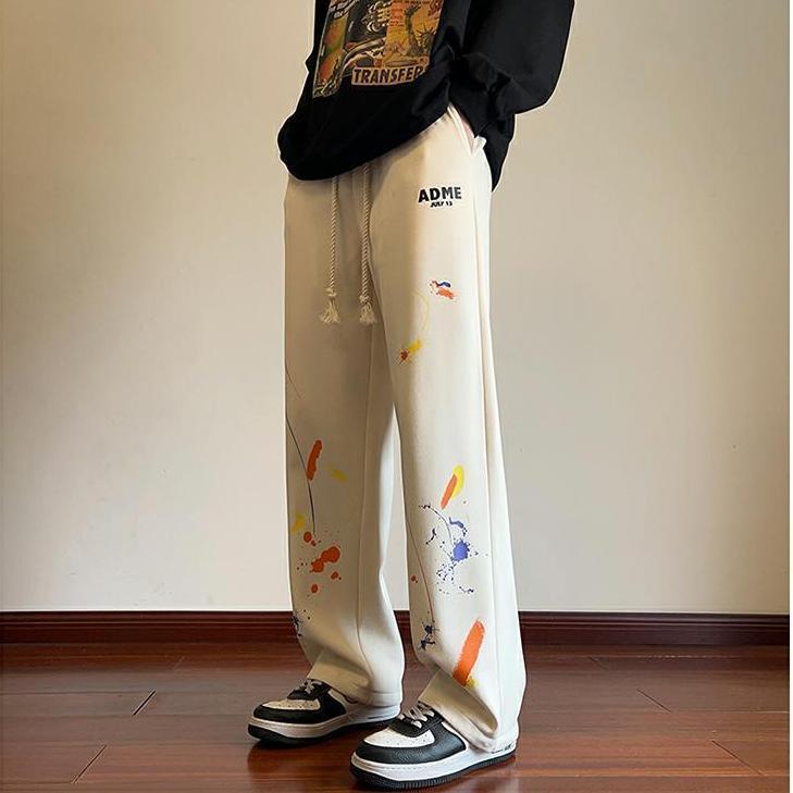 Celana olahraga grafiti pria, celana harem longgar kasual kaki lurus serbaguna gaya Korea musim semi