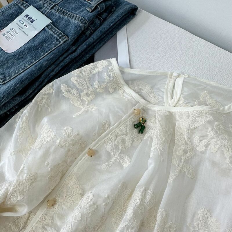 Camisa transpirable con bordado de aguja para mujer, camisa holgada con botones laterales, solapa oblicua, estilo temperamento, novedad de verano 2024