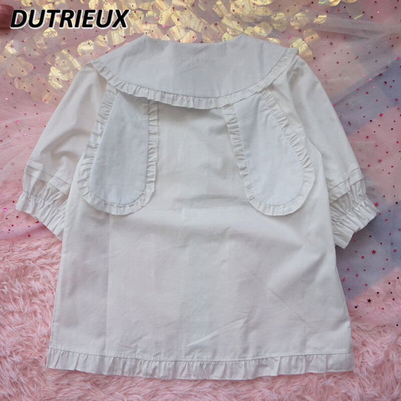 Lolita-Blusa de manga corta con lazo y Orejas de conejo para mujer, camisa holgada con volantes adelgazantes, Color sólido