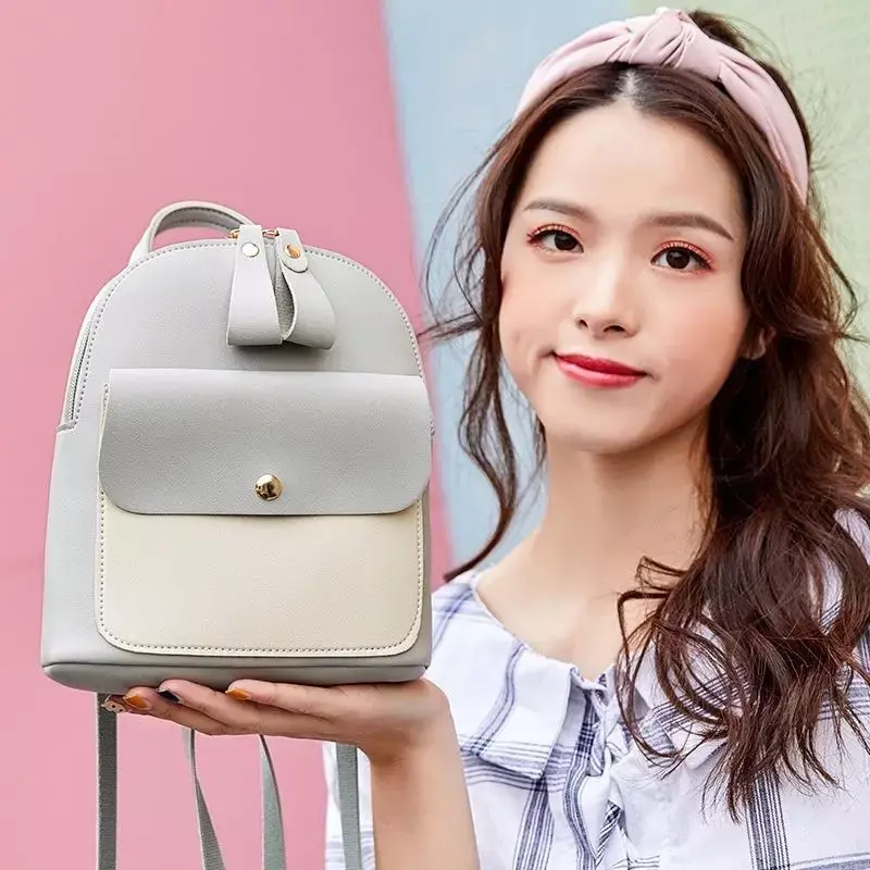 La nueva mochila pequeña versión coreana se puede inclinar a través de un hombro y tiene múltiples funciones, simples y coloridas