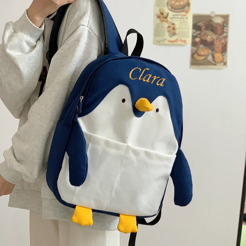 กระเป๋านักเรียนลายการ์ตูนเพนกวินน้อยสำหรับเด็กผู้หญิงกระเป๋าหนังสือสำหรับนักเรียนออกแบบชื่อได้เอง