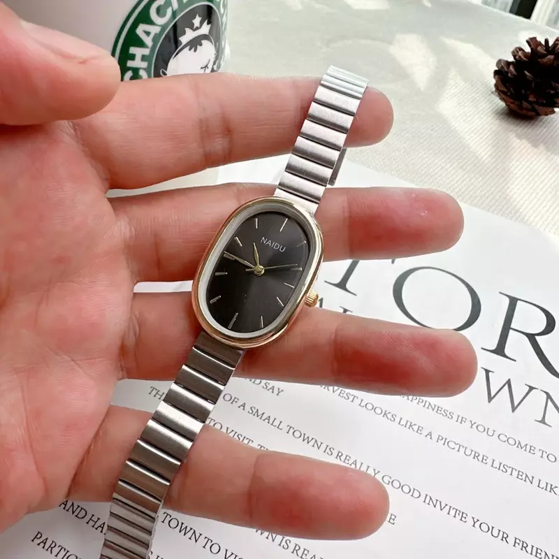 Женские часы с овальным циферблатом, Роскошные Кварцевые часы с ремешком из сплава для женщин, универсальные маленькие наручные часы со складной застежкой, 2023
