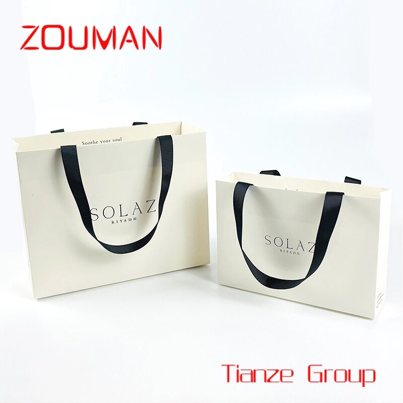Bolsas de papel impresas personalizadas, cartón de lujo, Papel Kraft blanco, bolsa de regalo con asa de cinta, bolsa de compras con su propio logotipo