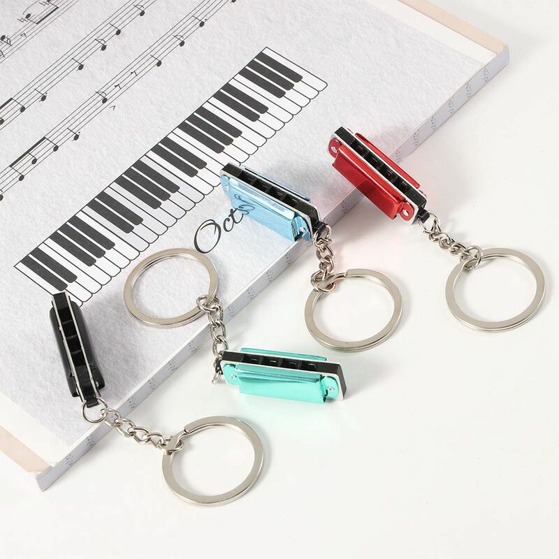 آلات موسيقية على شكل حقيبة قلادة ، أدوات رياح خشبية ، دواسات معلقة ، حامل مفاتيح ، سلسلة مفاتيح هارمونيكا ، حلقة مفاتيح متناسقة