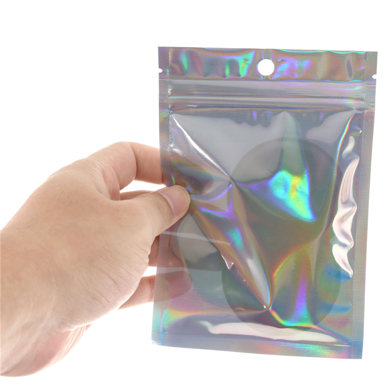プラスチック製の虹色のジッパーロックバッグ、化粧ポーチ、レーザーホログラフィックメイクアップバッグ、ホログラムジッパーバッグ、100個