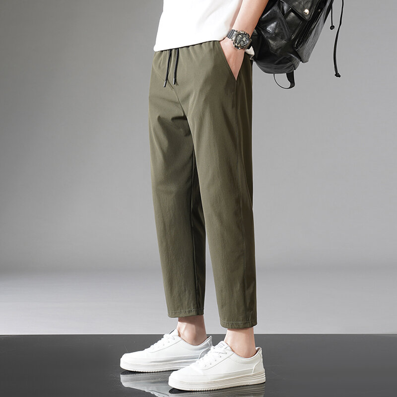 Celana panjang crop warna polos dasar pria, pakaian olahraga kasual Korea tali serut elastis bergaya kantong tipis musim panas