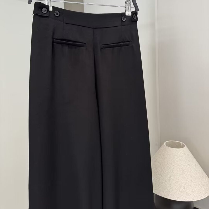 Pantalones plisados de estilo neutro negro con adornos de botones informales, nueva moda