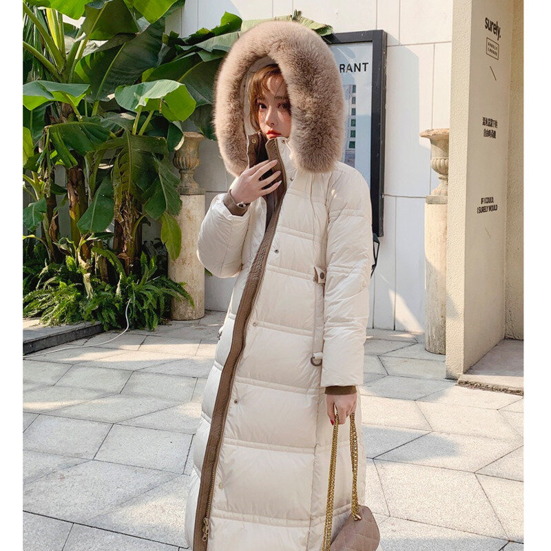 Piumino d'anatra bianco 2023 inverno nuovo coreano grande pelliccia artificiale con cappuccio cintura sottile elegante sopra il ginocchio moda solido lungo Parka