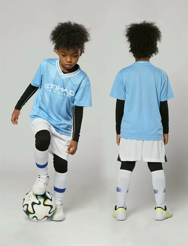 ชุดเสื้อเจอร์ซีย์สำหรับผู้ชายและเด็กแขนสั้นชุดเสื้อทีมฟุตบอลสำหรับเด็กชายและเด็กหญิง Kaus Sepak Bola