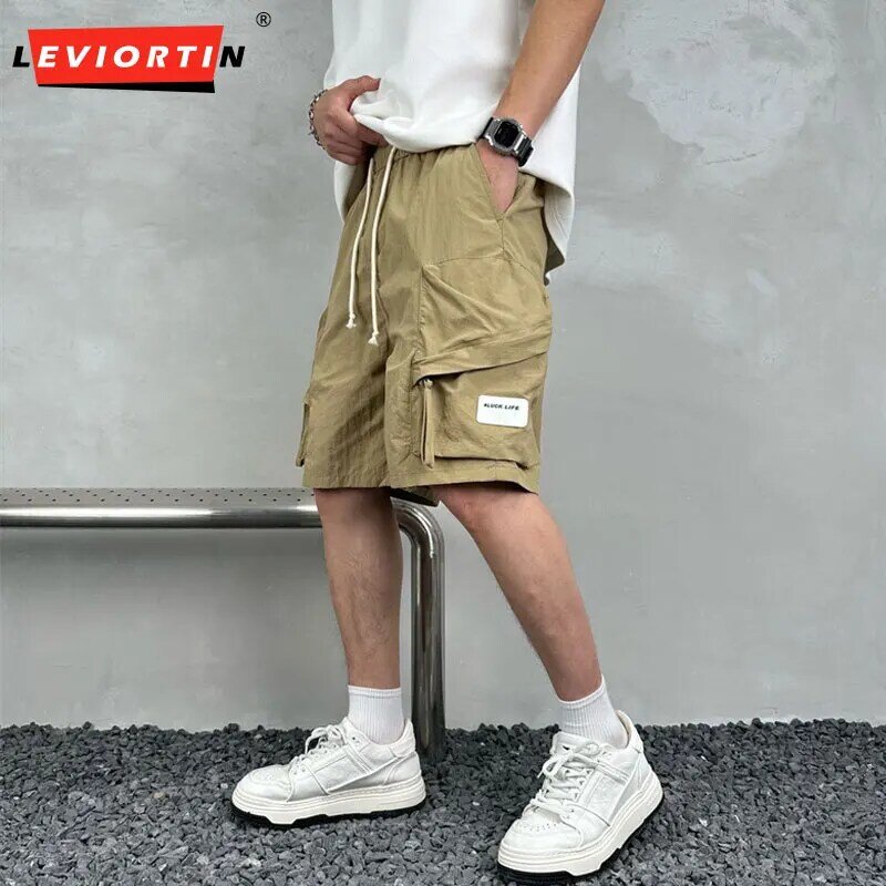 Pantaloncini Cargo larghi semplici di colore solido sottile Multi tasca estiva ad asciugatura rapida pantaloni sportivi a cinque punti alla moda Casual da uomo