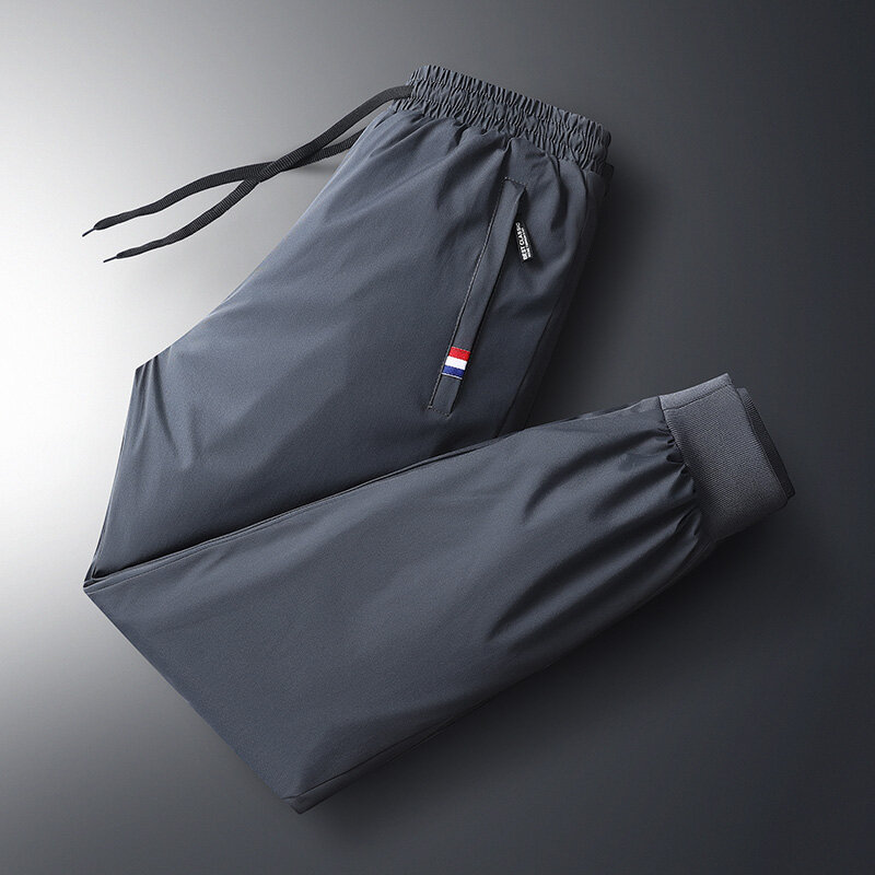 Spodnie na jesień męska elastyczna talia odzież sportowa nowa zima wodoodporne i ciepłe spodnie męskie duży rozmiar luźny, puchowy spodnie 7Xl