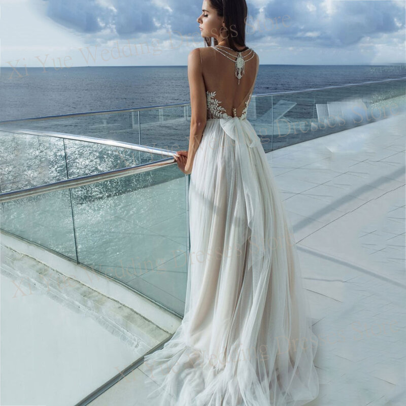 Eleganckie tiulowa suknia ślubna koronkowe aplikacje bez rękawów bez pleców suknie panny młodej urocze paski Spaghetti Vestido De Novia