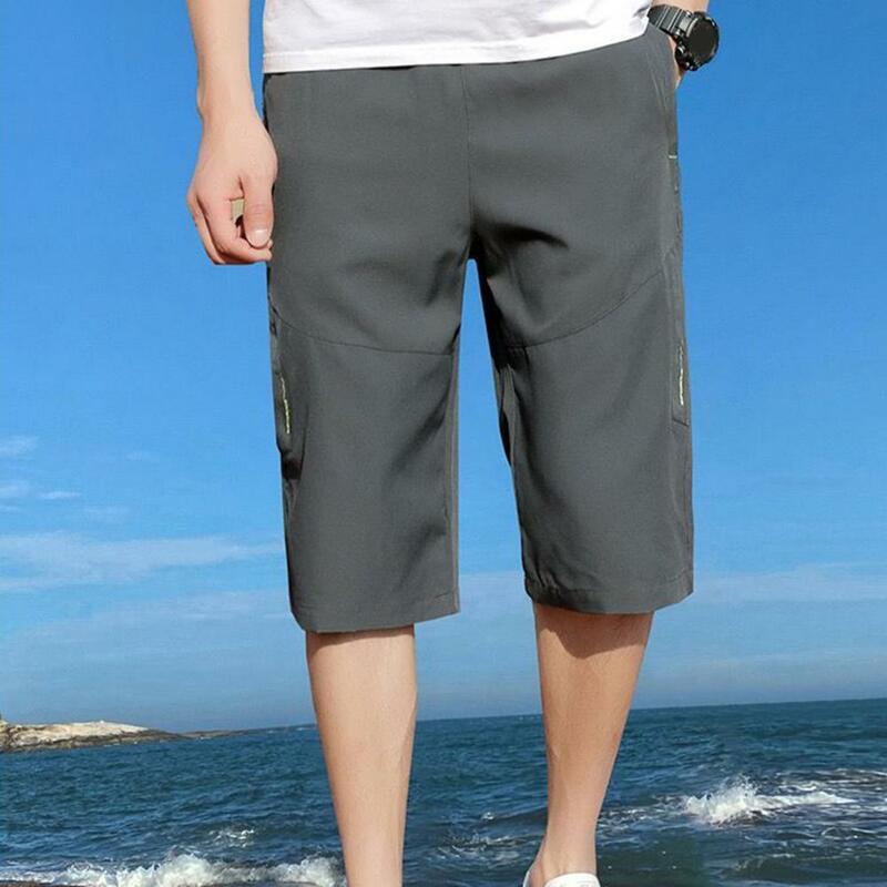 Pantalones cortos transpirables de Color sólido para hombre, longitud media pantorrilla, cintura elástica, bolsillos con cremallera, hielo suave y cómodo