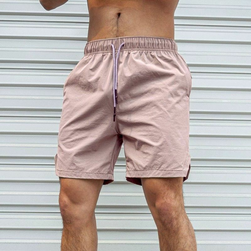Celana pendek kasual berenda elastis untuk pria, celana pendek warna polos longgar netral dengan saku bercetak huruf Musim Panas 2024