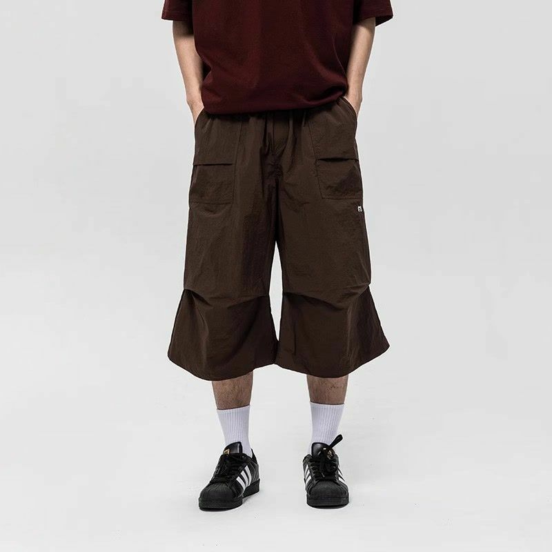 Celana panjang panggilan pinggang elastis pria, bawahan serut lipat saku longgar polos gaya Jepang trendi Musim Panas 2024