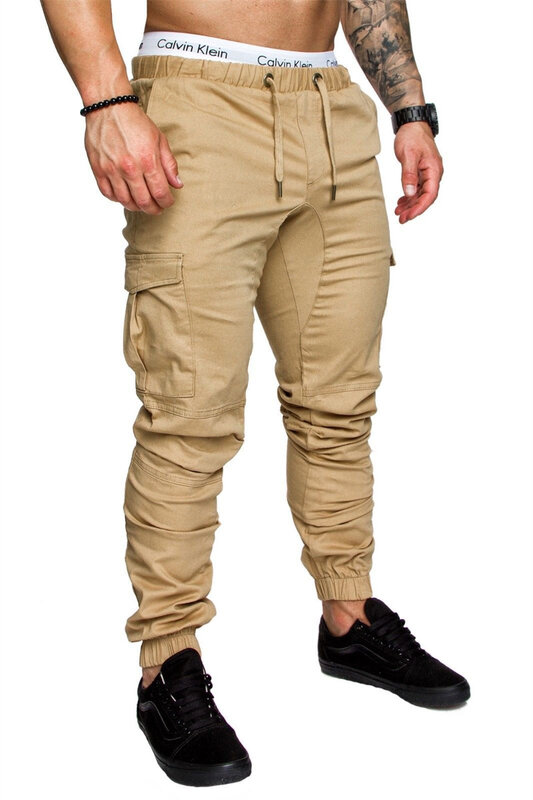 Pantalones deportivos de tela tejida para hombre, ropa deportiva informal, empalme con múltiples bolsillos, cintura suelta, con cordones, para las cuatro estaciones