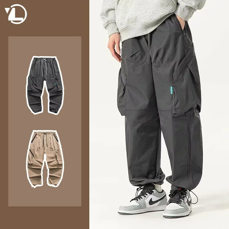 Modne męskie spodnie Cargo letnie w japońskim stylu Harajuku elastyczne z wieloma kieszeniami cienkie kombinezony ze sznurkiem z szerokimi nogawkami Trend w spodnie