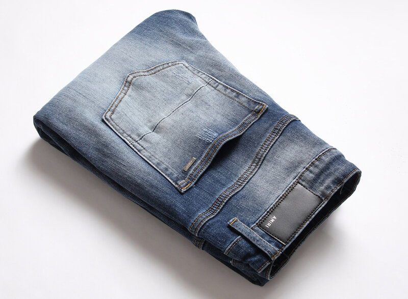 Wysokiej klasy porwane jeansy męska marka modowa AM główna ulica naszywka osobowość jesienno-zimowa rozciągliwe dopasowanie stopy długie spodnie