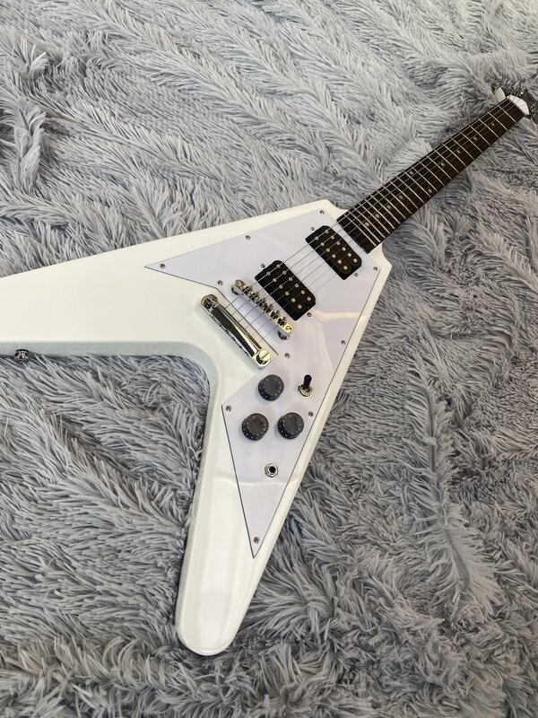 High quality electric guitar, V-design, silver lacquer, HH pickups, fingerboard mother-of-pearl inlay. Free shipping in stock