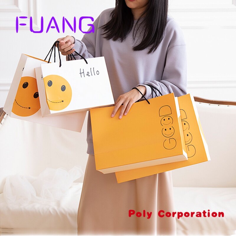 Produsen Cina tas hadiah anak-anak desain tersenyum ramah lingkungan Logo kustom tas kertas belanja Promosi