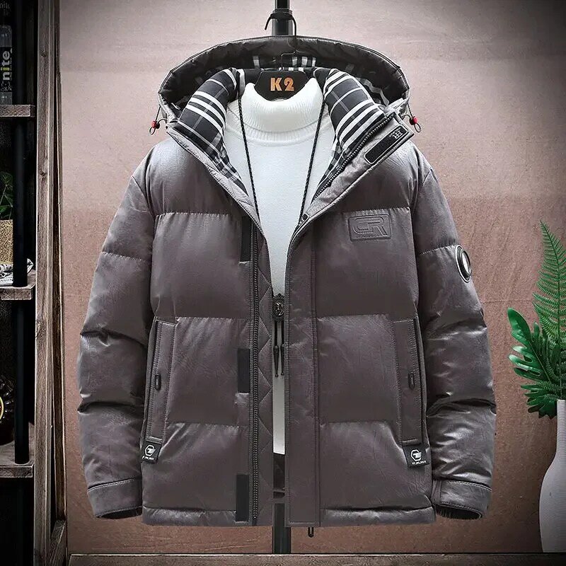 Zimowa nowa męska moda płaszcz z kapturem męska krótka gęsta ciepła odporna na zimno ubrania wyściełane bawełną Casual duży rozmiar luźna odzież
