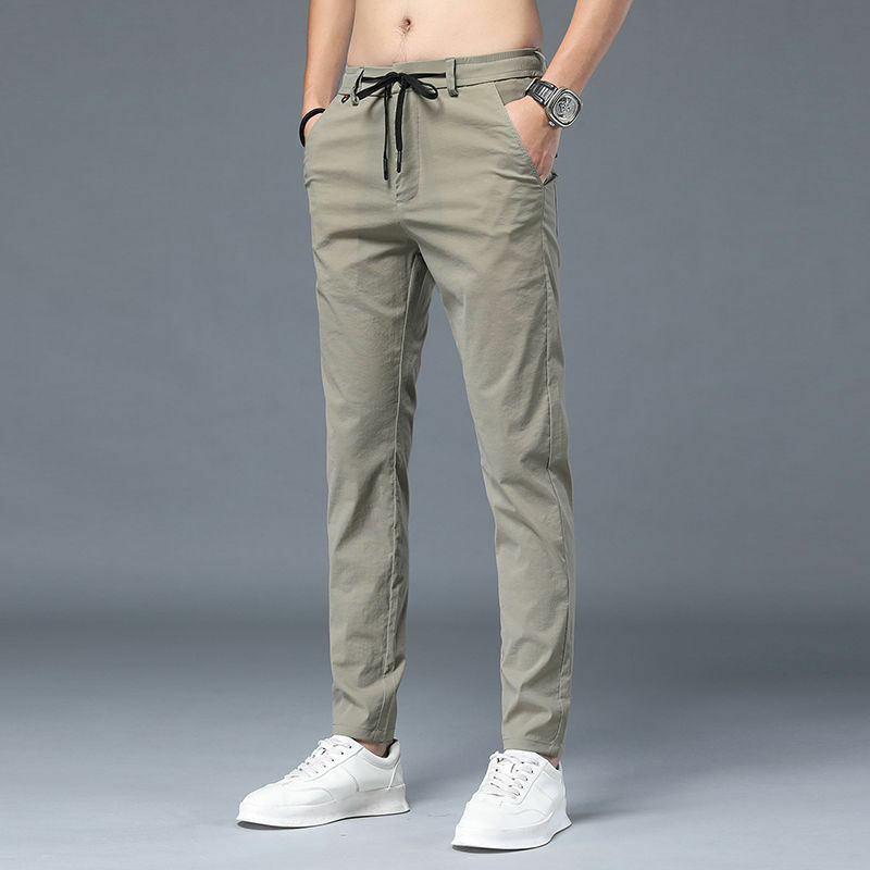 Celana panjang lurus trendi edisi Korea, celana panjang olahraga tipis saku serut pinggang elastis polos pria musim panas