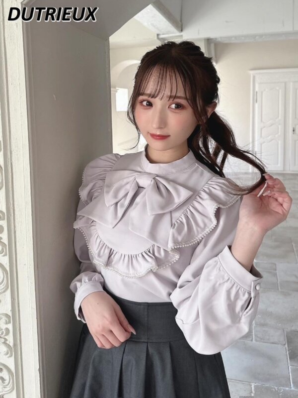 Japońska masowo produkowana duża kokarda koszula z długim rękawem dla kobiet Lolita słodka kokardka delikatna, dopasowana, biała bluzka z falbanką