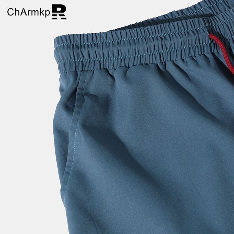 Charmmk 2024 celana pria, bawahan panjang longgar kasual tali serut perca blok warna untuk lelaki